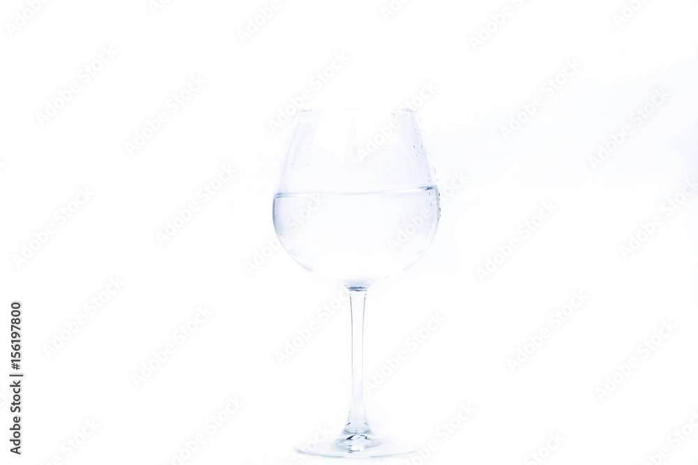 Crystal wineglass with water stands on white background Crystal wineglass with water stands on white background