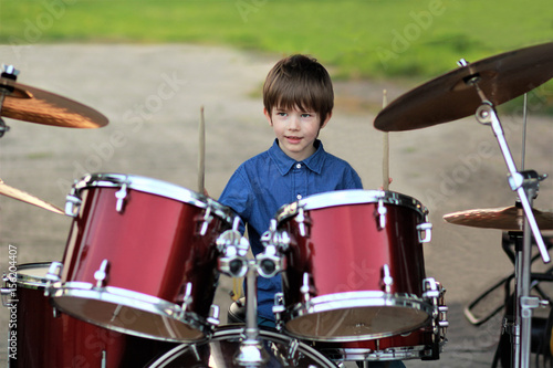 фотографія Boy learning to drum at the open air festival