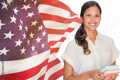 students holding books against american flag  photo