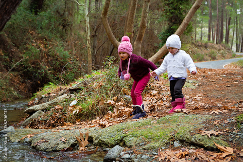 Little Sisters Playing by the Creek