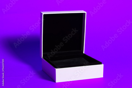 Opened white gift box on a violet background