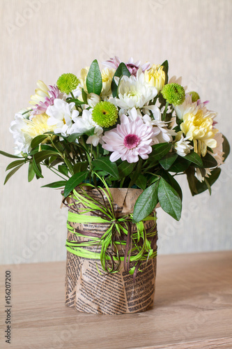 Wallpaper Mural Bouquet of different chrysanthemums in paper with bow on wood. Torontodigital.ca