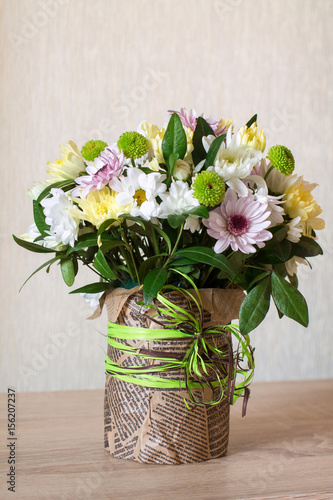 Wallpaper Mural Bouquet of different chrysanthemums in paper with bow on wood. Torontodigital.ca