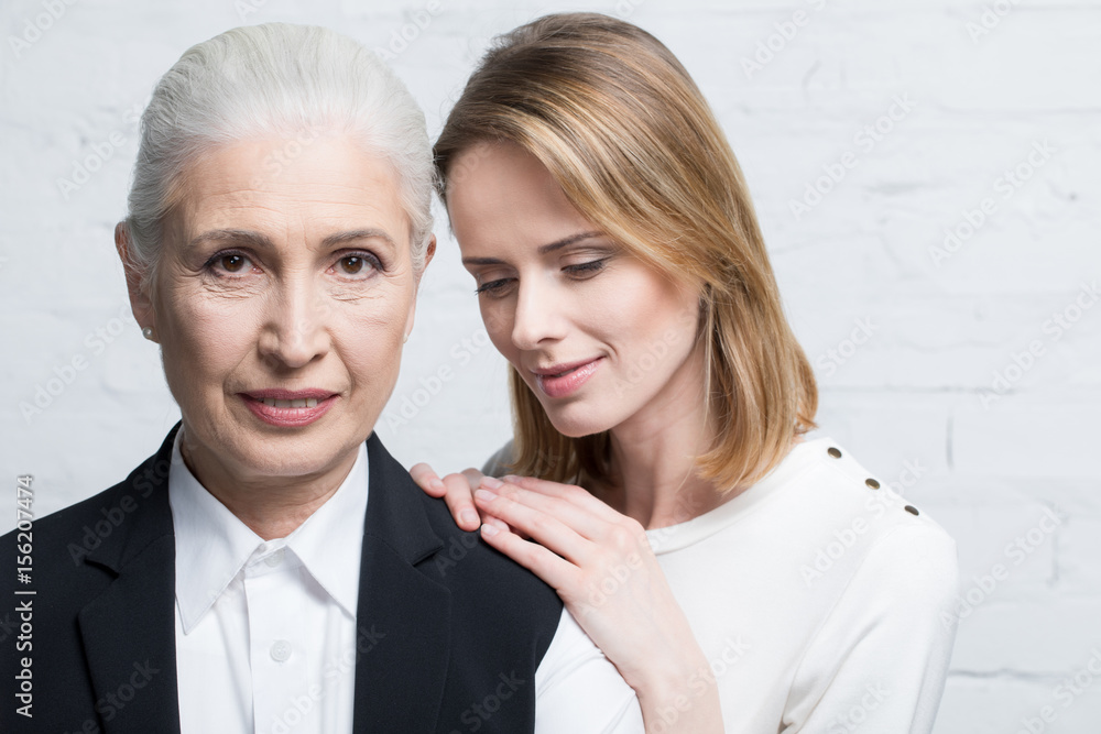 Portrait of beautiful women standing together, young and senior people Portrait of beautiful women standing together, young and senior people