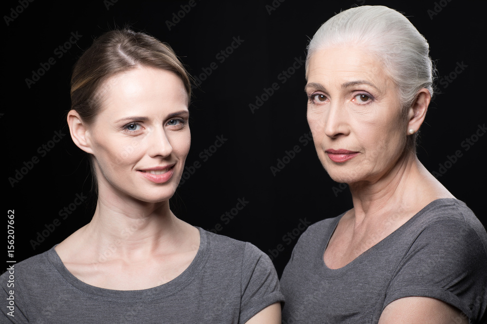 portrait of women looking at camera, young and senior people isolated on black portrait of women looking at camera, young and senior people isolated on black
