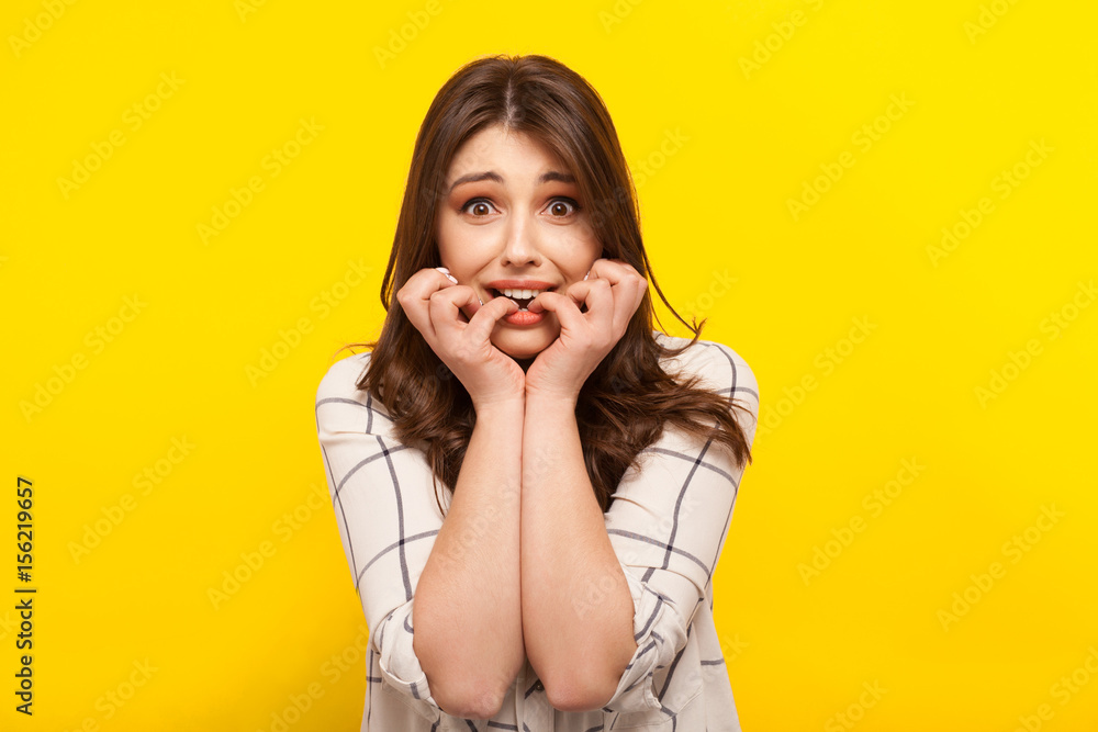 Scared girl posing on yellow Scared girl posing on yellow