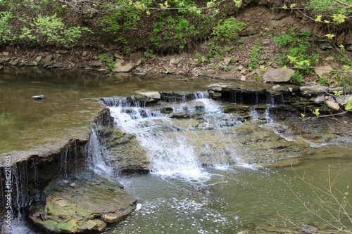 The waterfall ate the end of the creek. 