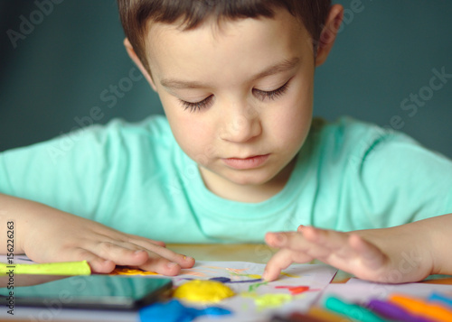 Boy playing with color play dough