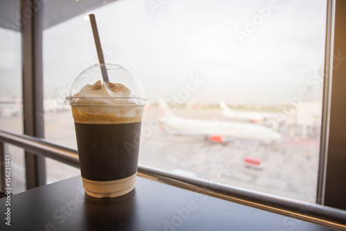 Cup of ice coffee. travelling relax time waiting for the journey coming. photo