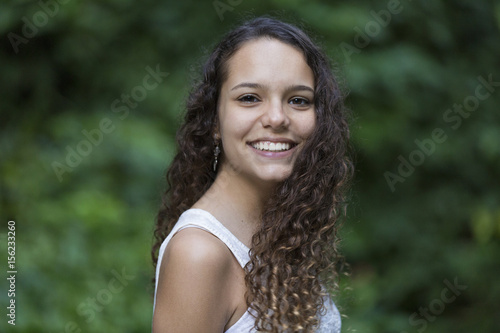 Portrait of Teenage Girl Laughing / Portrait of Brunette Teenage Girl Laughing in a Park