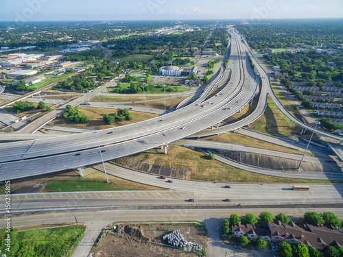 Aerial view massive interstate I69 highway intersection, stack interchange with elevated road junction overpass in downtown Houston. This five-level freeway interchange carry heavy rush hour traffic. photo