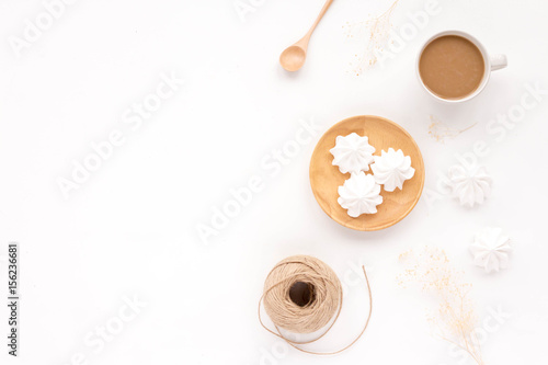 Breakfast with cup of coffee, flowers on white background. Flat lay, top view, mock up
