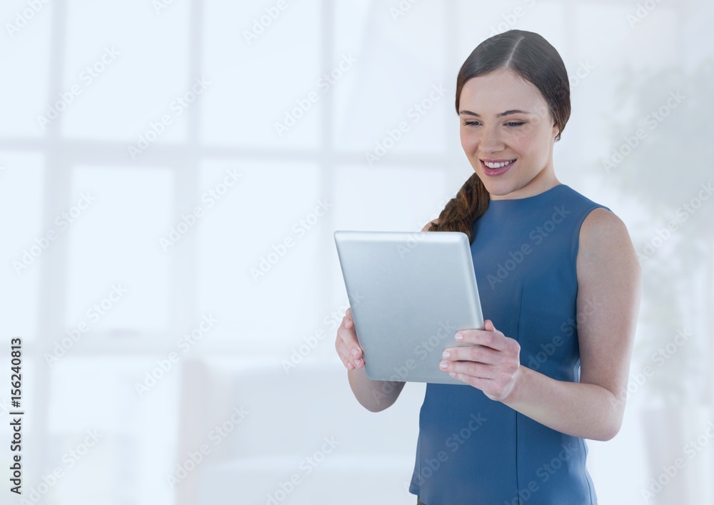Businesswoman holding tablet in office by bright window Businesswoman holding tablet in office by bright window