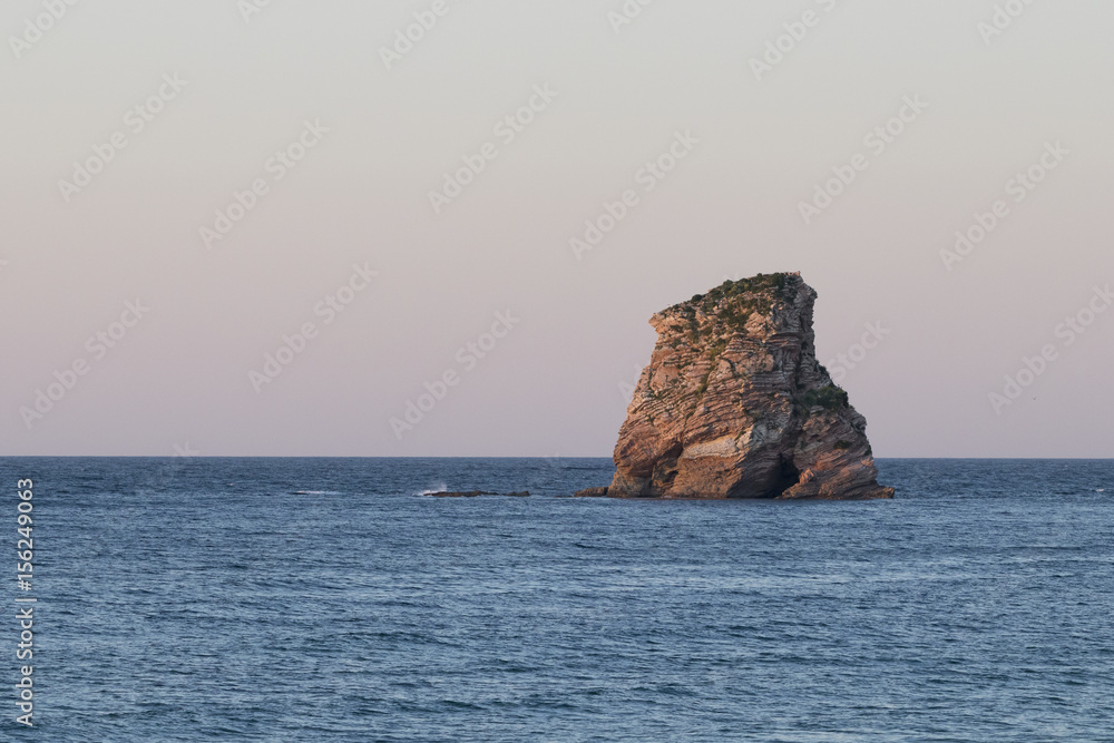 Lonely rock island at sunset (Hendaye, France). Lonely rock island at sunset (Hendaye, France).