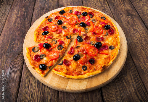 Delicious pizza with salami, mushrooms and olives