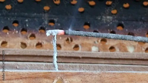 Incense sticks in a bowel on a wooden table with incense smoke. Incense sticks in a bowel on a wooden table with incense smoke. photo