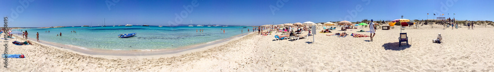FORMENTERA, SPAIN - JUNE 2015: Tourists enjoy wonderful island beach, panoramic view. Formentera is a famous tourist destination in Spain