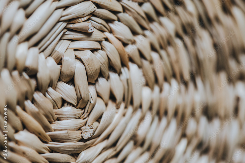 Fototapeta premium Handmade authentic straw round basket macro closeup geometric texture.