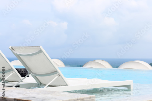 Beach lounge swimming pool with pool bed or Sundeck on Sea view for vacation, Relax vacation time with nice place at sea beach in Thailand © bookybuggy