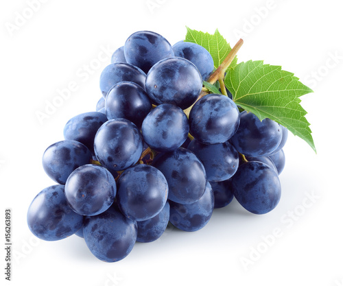 Leinwand Poster Dark blue grape with leaves isolated on white background