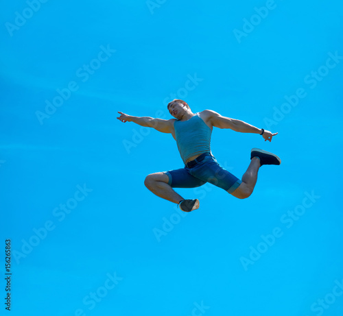 Wallpaper Mural Jumping up guy. Background blue sky. Torontodigital.ca
