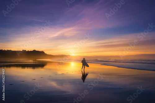 surfer in the beach at sunset © mimadeo
