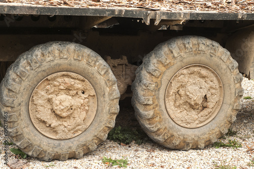 Muddy grunge tyre wheels of heavy duty truck closeup