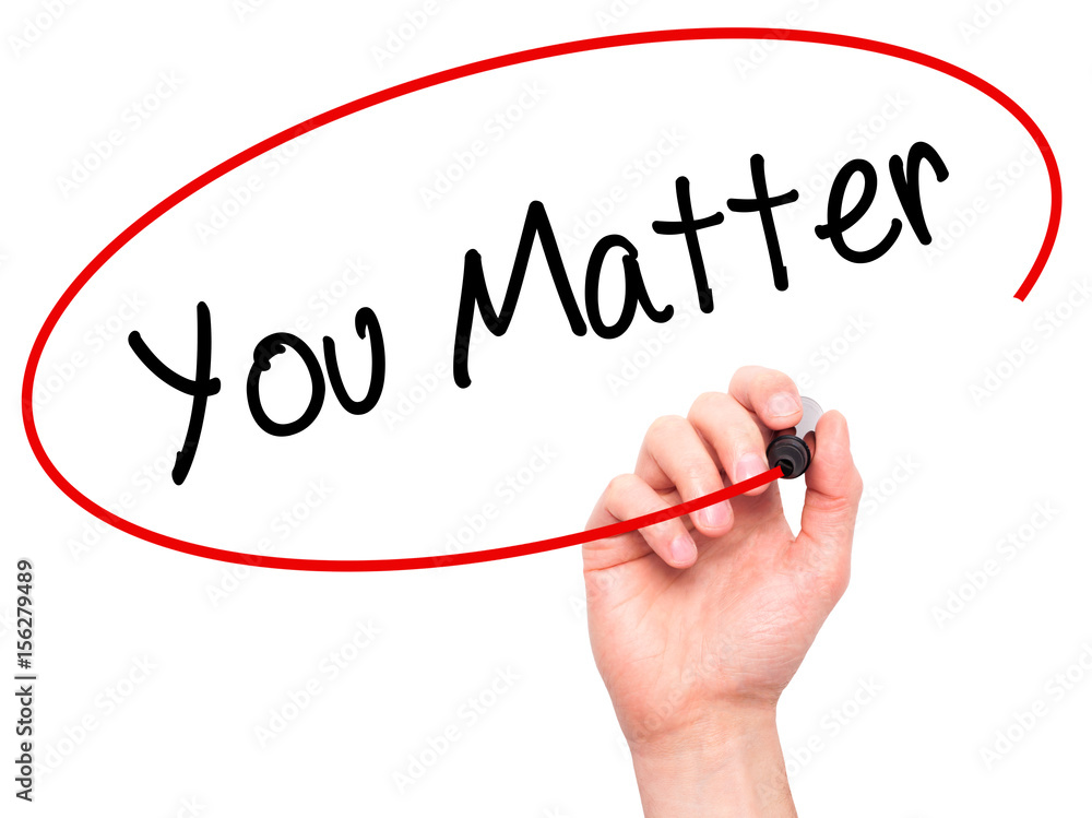Man Hand writing You Matter with black marker on visual screen Man Hand writing You Matter with black marker on visual screen