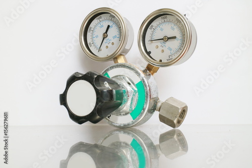 Cylinder pressure regulator gauge isolated on a white background.