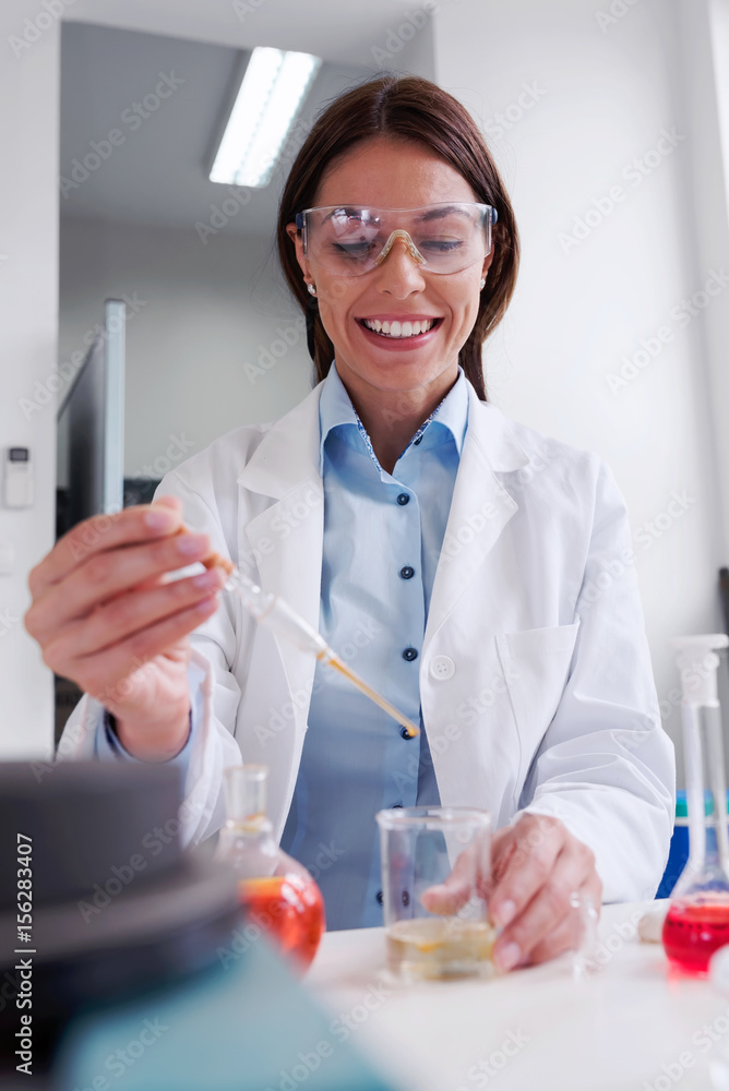 Scientist carrying out experiment in research laboratory. Medical chemist lab. Scientist carrying out experiment in research laboratory. Medical chemist lab.