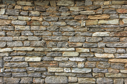 Natural grunge brown stone wall background and texture.