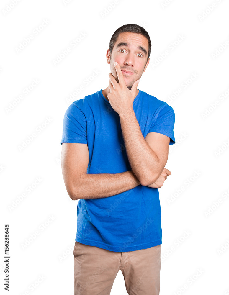 Doubtful young man against white background Doubtful young man against white background