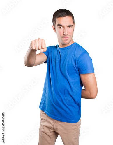 Angry young man against white background