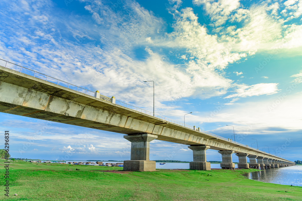 Long concrete bridge crosses the lake.