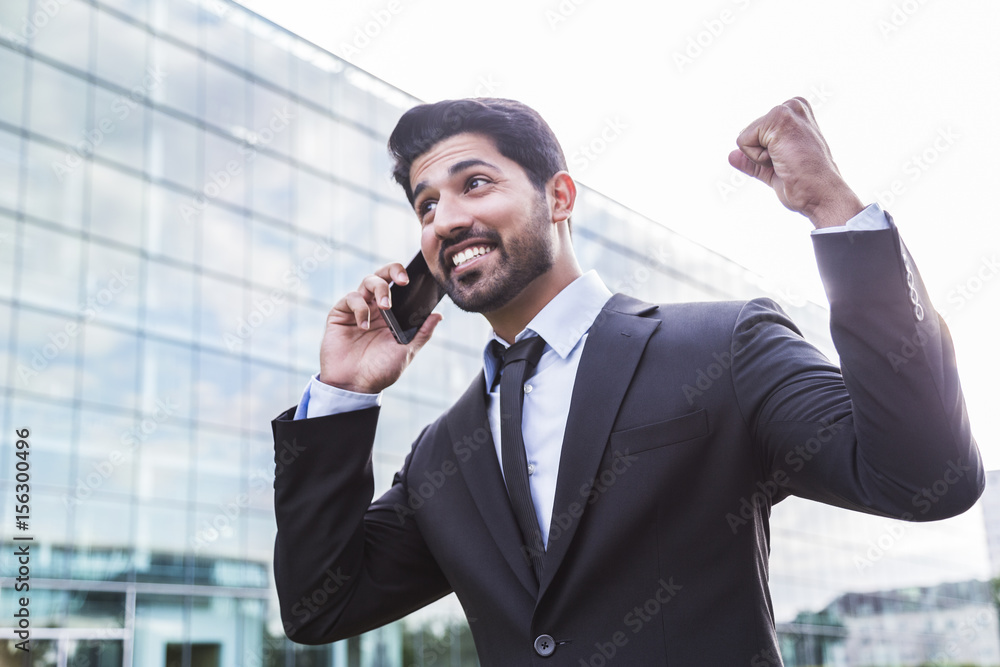 Successful businessman or worker in suit with phone near office building Successful businessman or worker in suit with phone near office building