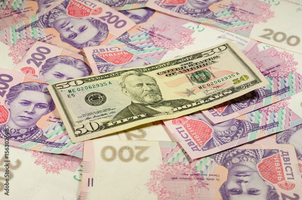 Fifty dollars banknote on the background of ukrainian hryvnas Fifty dollars banknote on the background of ukrainian hryvnas