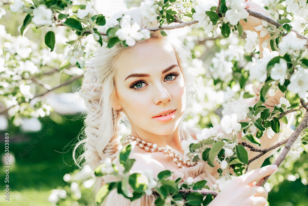 Beautiful bride in a blossoming garden close-up face Beautiful bride in a blossoming garden close-up face