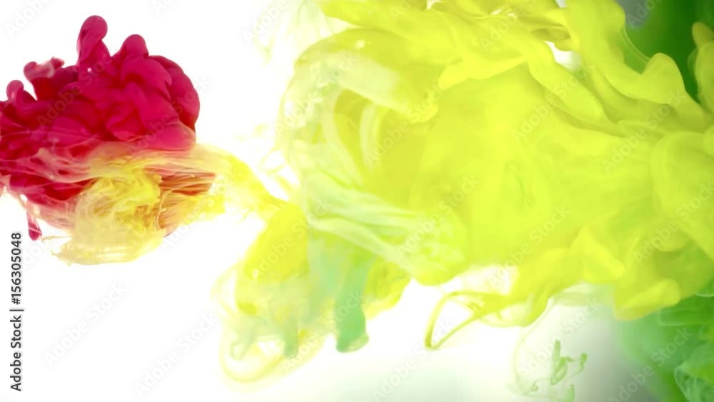 Ink of yellow, green and red color pouring into water on white background texture Ink of yellow, green and red color pouring into water on white background texture