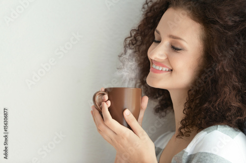 Young woman with cup of aro...