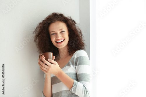 Young woman with cup of aro...
