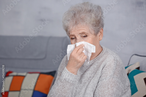 Mature ill woman with tissu...