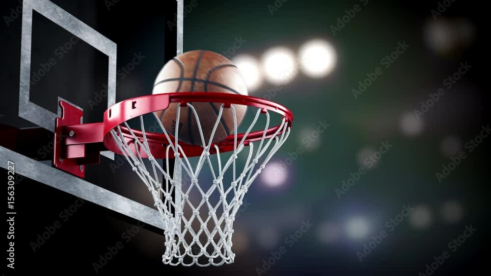 A throw basketball ball in a ring on the background of spotlights A throw basketball ball in a ring on the background of spotlights