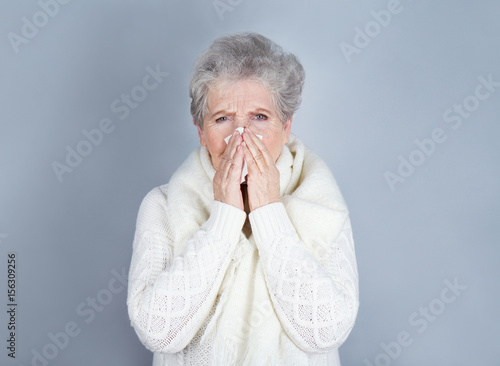 Mature ill woman with tissu...