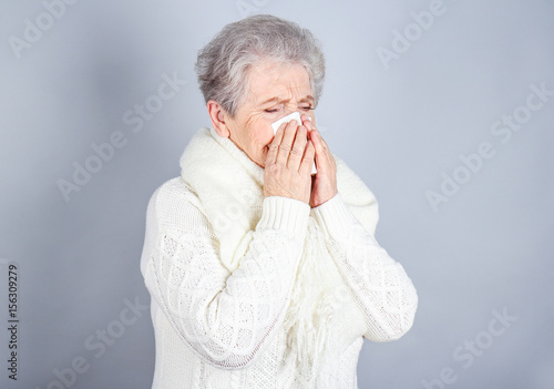 Mature ill woman with tissu...