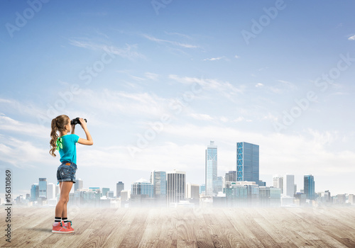 Concept of careless happy childhood with girl dreaming about future