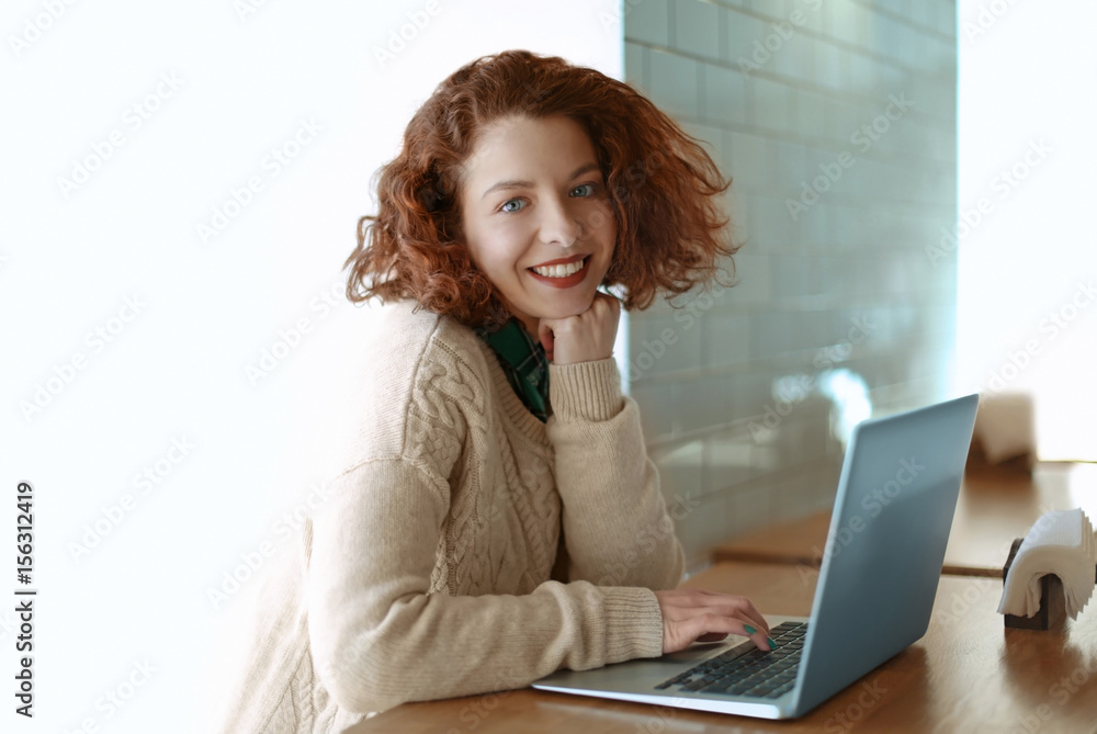Beautiful girl with laptop in cafe Beautiful girl with laptop in cafe