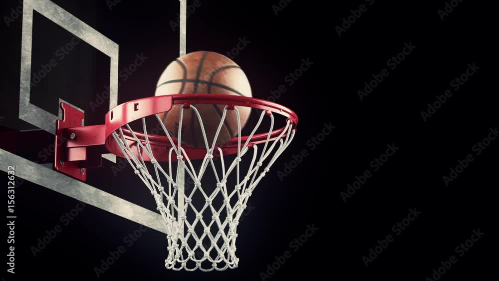 A throw basketball ball in a ring on a black background A throw basketball ball in a ring on a black background