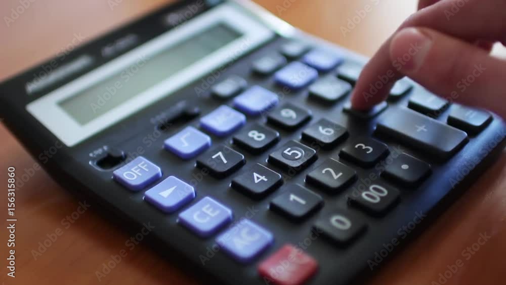 Counting on calculator. Finger presses the button calculator Counting on calculator. Finger presses the button calculator