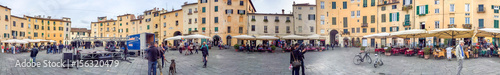 LUCCA, ITALY - APRIL 2015: Tourists along city square, panoramic view. Lucca is a major destination in Tuscany