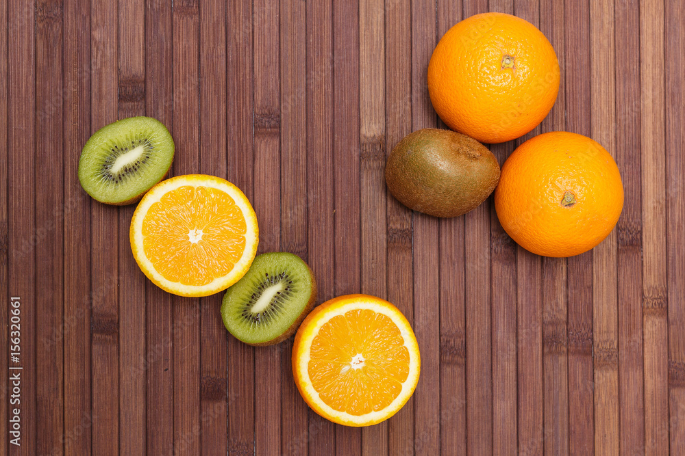Fresh fruits kiwi, orange isolated on wooden background. Healthy food. A mix of fresh fruit. Group of citrus fruits. Vegetarian raw fruit. Nutrition for a healthy lifestyle. Fresh fruits kiwi, orange isolated on wooden background. Healthy food. A mix of fresh fruit. Group of citrus fruits. Vegetarian raw fruit. Nutrition for a healthy lifestyle.